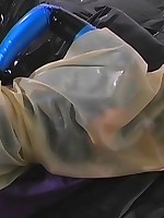 Girl in a blue latex catsuit struggled in bondage