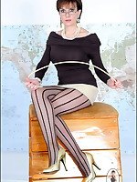 Stern Domme in striped stockings teases camera