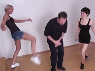 Two young foot dommes are teaching a male slave to worship