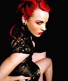 Redhead glamgoth spreads wide in antique corset