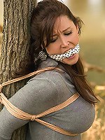 gagged and strapped to the tree